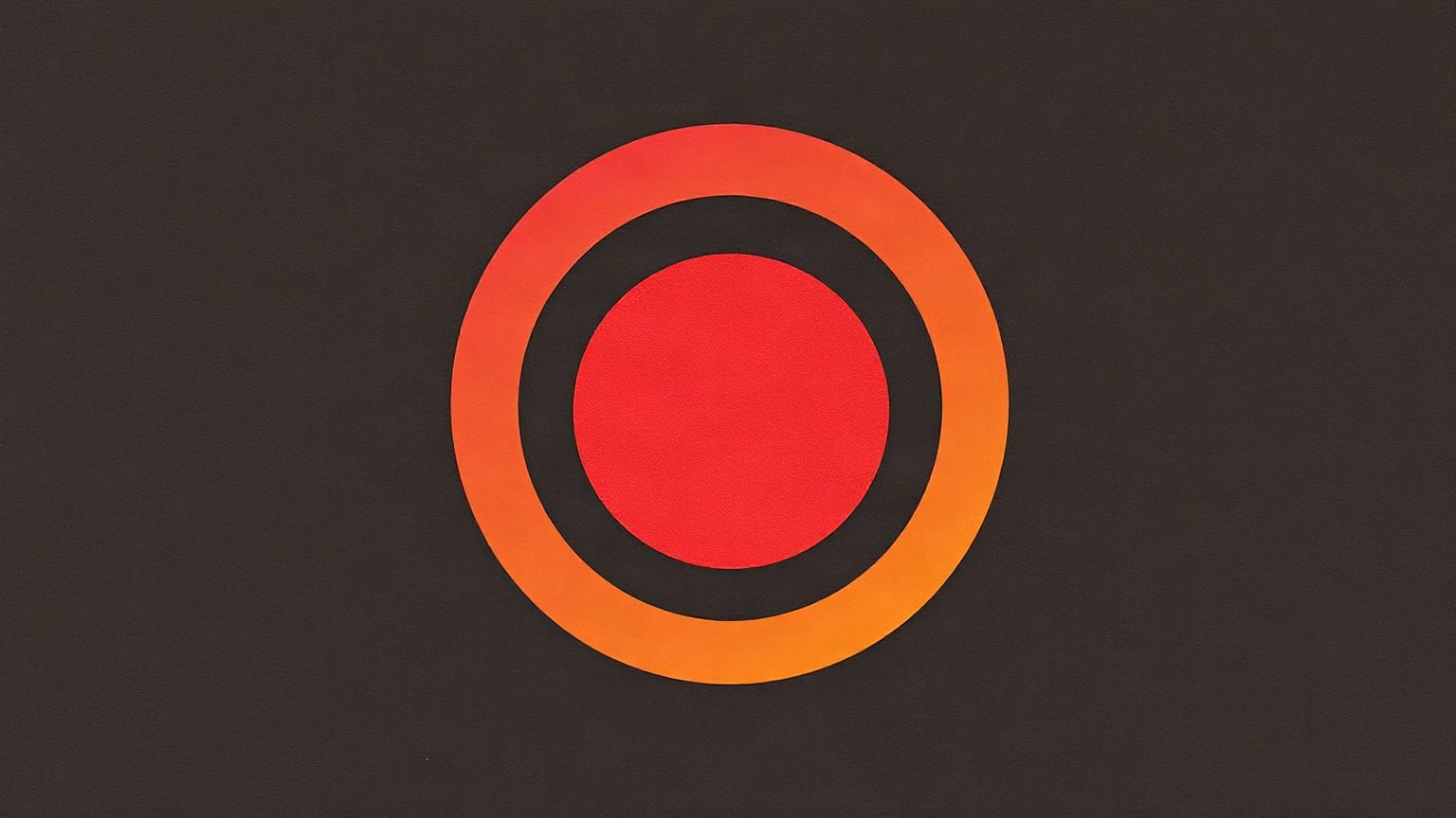 A flat orange paper ring with a red disc inside it, centred on a near-black ground