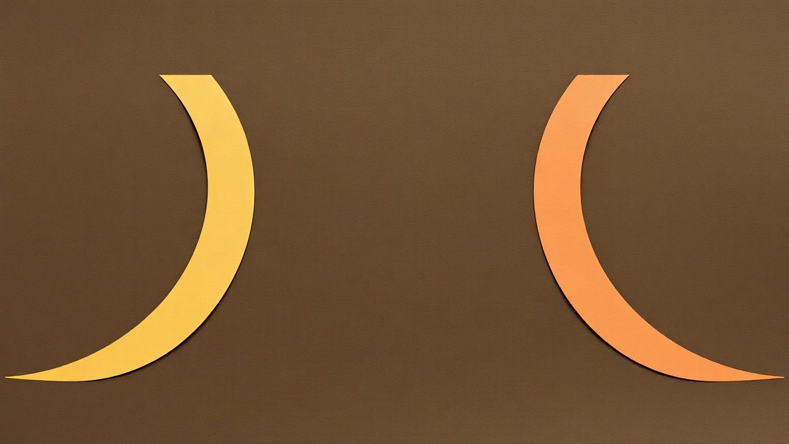 Two tall paper crescents facing each other across a brown ground, one yellow and one orange