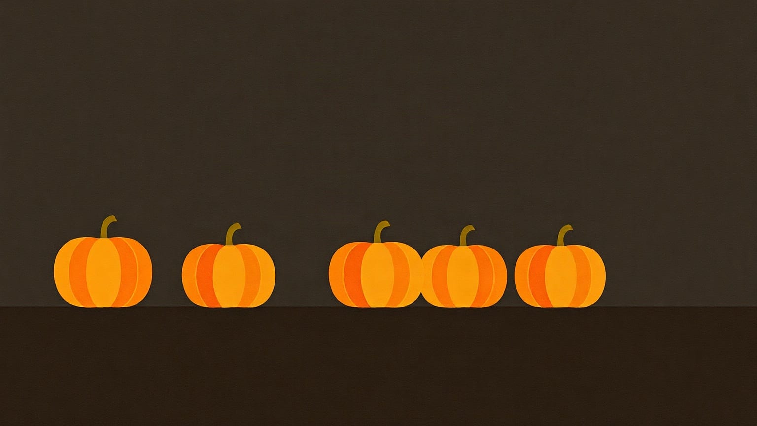 Five paper pumpkins of slightly different sizes standing in a row on a ledge against a dark brown wall