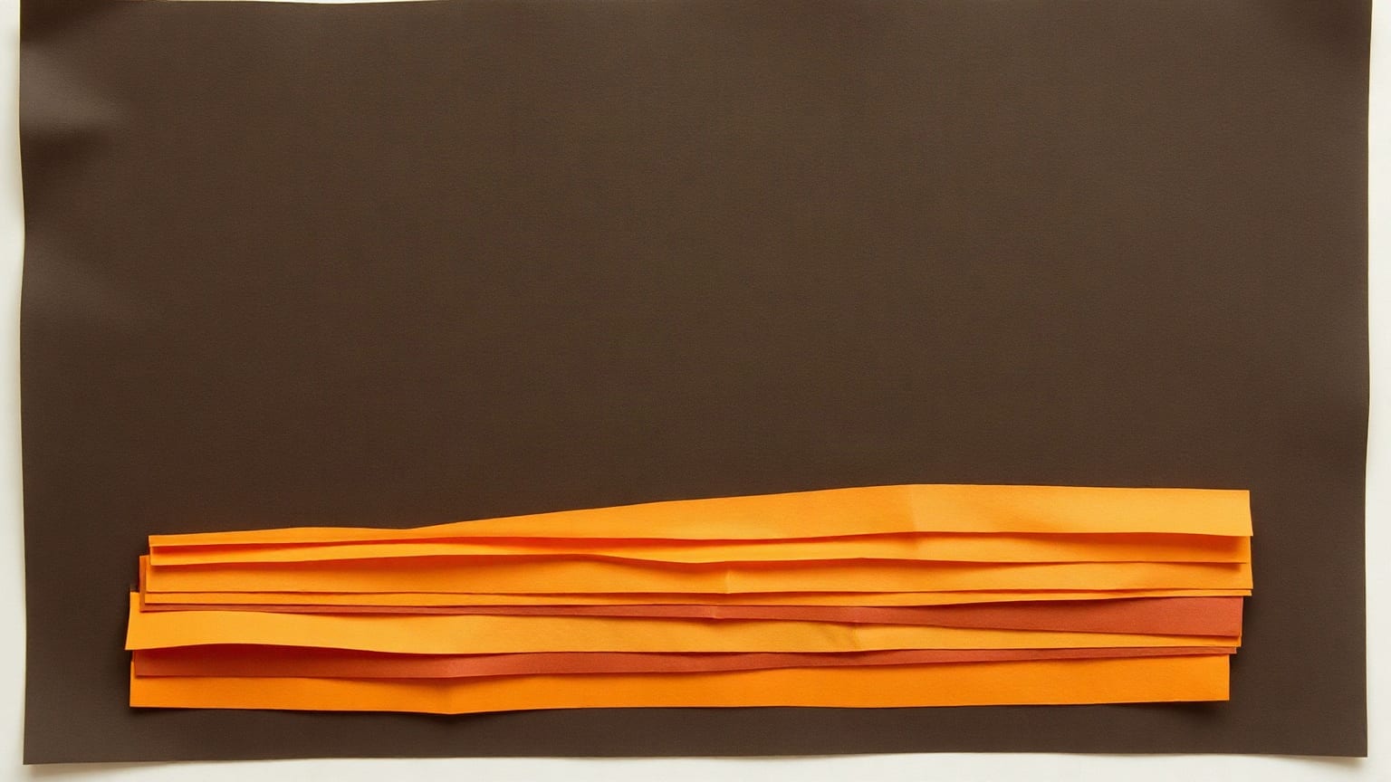 Horizontal strips of amber and orange paper stacked like sediment layers on a dark brown ground
