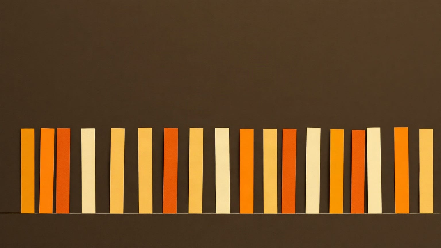 A long row of narrow paper bars in amber, ochre and cream, standing together on one level line, on a dark brown ground
