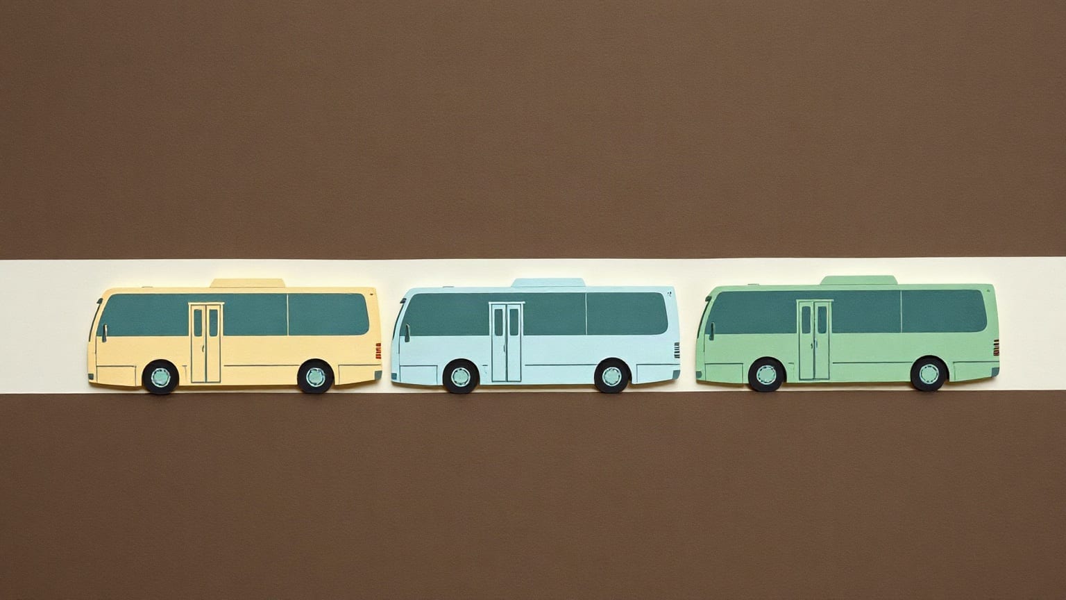 Three paper buses in cream, pale blue and green parked side by side on a brown ground